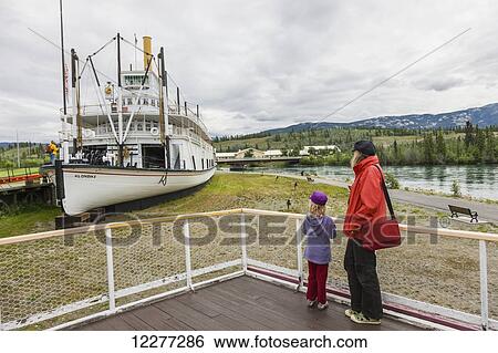 Mother and daughter stand on a viewing platform looking at the SS Klondike, Whitehorse, Yukon Territory, Canada, summer View Large Photo Image Stock Photograph - Mother and daughter stand on a viewing platform looking at the SS Klondike, Whitehorse, Yukon Territory, Canada, summer. Fotosearch