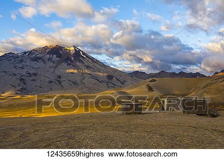 Stock Photograph - Mt. Griggs rises over the Valley of Ten Thousand Smokes and the Baked Mountain Huts in Katmai National Park; Alaska, United States of America. Fotosearch