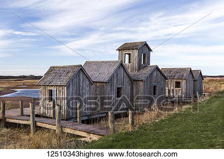 Stock Photograph - Natural wooden structures on a boardwalk on a beach along the coast; Prince Edward Island, Canada. Fotosearch