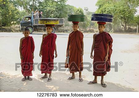 Novice buddhist monks carrying food on their heads; Bagan, Myanmar View Large Photo Image Stock Image - Novice buddhist monks carrying food on their heads; Bagan, Myanmar. Fotosearch