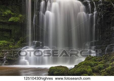 Numerous waterfalls flowing over rocks into a pool in the Yorkshire Dales; Settle, North Yorkshire, England View Large Photo Image Stock Photograph - Numerous waterfalls flowing over rocks into a pool in the Yorkshire Dales; Settle, North Yorkshire, England. Fotosearch