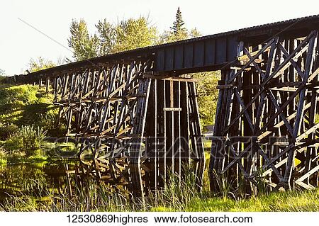 Stock Photograph - Old Iconic Wooden Trestle Bridge Over The Sturgeon River; St. Albert. Alberta, Canada. Fotosearch