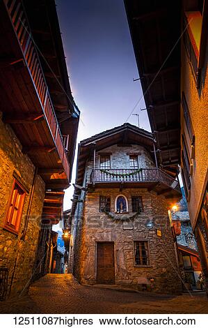 Old stone buildings and ancient cobblestone streets illuminated at dusk, Dolonne, near Courmayeur, Aosta Valley, Italy View Large Photo Image Stock Photograph - Old stone buildings and ancient cobblestone streets illuminated at dusk, Dolonne, near Courmayeur, Aosta Valley, Italy. Fotosearch