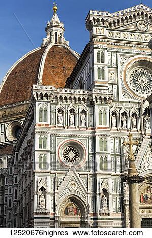 Stock Photograph - Ornate and decorative facade of Florence Cathedral with dome and blue sky; Florence, Tuscany, Italy. Fotosearch