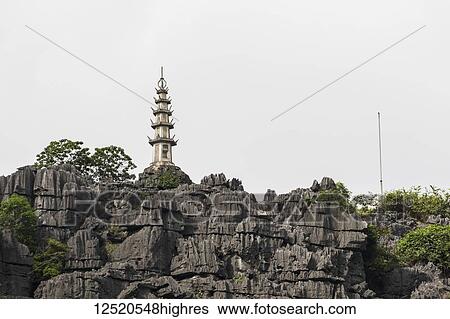 Stock Photograph - Pagoda by the Ngo Dong River; Tam Coc, Ninh Binh, Vietnam. Fotosearch