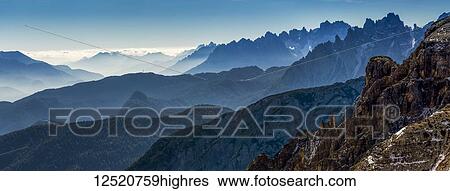 Stock Photograph - Panorama of silhouetted rugged mountain range; Sesto, Bolzano, Italy. Fotosearch
