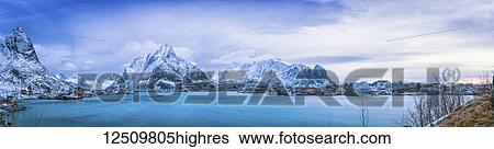 Panoramic of the rugged mountains along the coastline of Norway at sunrise under a blue hue; Svolvar, Lofoten Islands, Nordland, Norway View Large Photo Image Stock Photograph - Panoramic of the rugged mountains along the coastline of Norway at sunrise under a blue hue; Svolvar, Lofoten Islands, Nordland, Norway. Fotosearch
