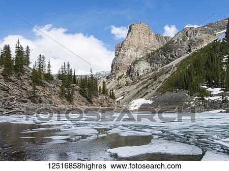 Partially frozen Moraine Lake, Banff National Park; Alberta, Canada View Large Photo Image Stock Photograph - Partially frozen Moraine Lake, Banff National Park; Alberta, Canada. Fotosearch