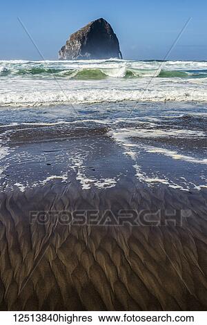 Patterns found on the beach with a large rock formation out from the shore, Cape Kiwanda; Pacific City, Oregon, United States of America View Large Photo Image Stock Photograph - Patterns found on the beach with a large rock formation out from the shore, Cape Kiwanda; Pacific City, Oregon, United States of America. Fotosearch