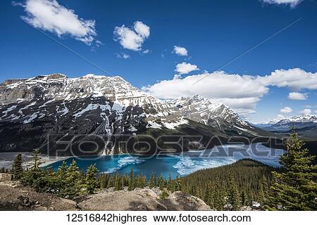 Stock Photograph - Peyto Lake with some ice on the turquoise water in the Canadian Rocky Mountains near Banff; Alberta, Canada. Fotosearch