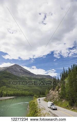 Pick up truck and travel trailer on the Alaska Highway running along the Toad River, Muncho Lake Provincial Park, British Columbia, Canada, Summer View Large Photo Image Picture - Pick up truck and travel trailer on the Alaska Highway running along the Toad River, Muncho Lake Provincial Park, British Columbia, Canada, Summer. Fotosearch