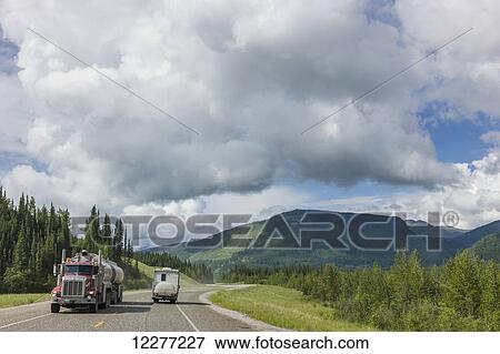 Pick up truck camper drives past a semi truck on the Alaska Highway, west of Fort Nelson, British Columbia Canada, Summer View Large Photo Image Stock Photo - Pick up truck camper drives past a semi truck on the Alaska Highway, west of Fort Nelson, British Columbia Canada, Summer. Fotosearch