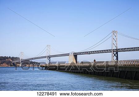Pier 14 and the Oakland Bay Bridge; San Francisco, California, United States of America View Large Photo Image Stock Image - Pier 14 and the Oakland Bay Bridge; San Francisco, California, United States of America. Fotosearch