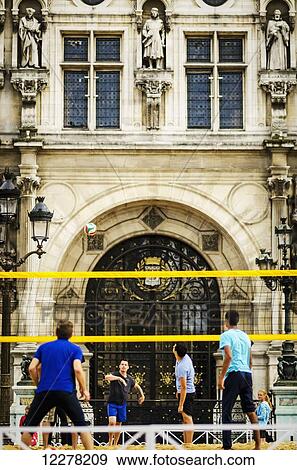 Players prepare to strike the ball from a serve at a game of volleyball in front of a historic building; Paris, France View Large Photo Image Stock Photo - Players prepare to strike the ball from a serve at a game of volleyball in front of a historic building; Paris, France. Fotosearch