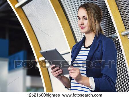Portrait of a beautiful young millennial professional business woman using technology in the workplace; St. Albert, Alberta, Canada View Large Photo Image Stock Photograph - Portrait of a beautiful young millennial professional business woman using technology in the workplace; St. Albert, Alberta, Canada. Fotosearch