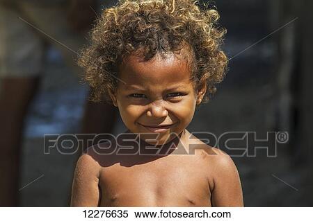 Portrait of a boy with curly hair; Manatuto, East Timor View Large Photo Image Stock Photography - Portrait of a boy with curly hair; Manatuto, East Timor. Fotosearch