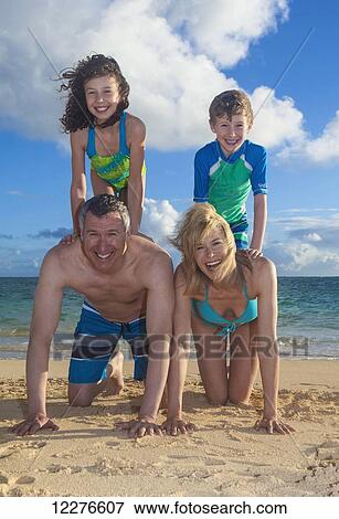Portrait of a family on the beach on a hawaiian island; Kailua, Island of Hawaii, Hawaii, United States of America View Large Photo Image Stock Photo - Portrait of a family on the beach on a hawaiian island; Kailua, Island of Hawaii, Hawaii, United States of America. Fotosearch