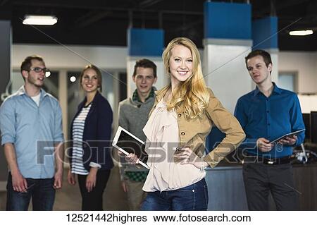 Portrait of a group of young millennial professionals standing together in the workplace; Sherwood Park Alberta, Canada View Large Photo Image Stock Photograph - Portrait of a group of young millennial professionals standing together in the workplace; Sherwood Park Alberta, Canada. Fotosearch