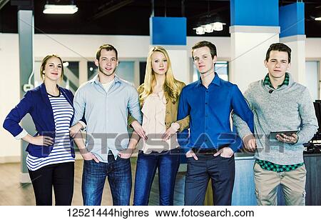 Portrait of a group of young millennial professionals standing arm in arm together in the workplace; Sherwood Park Alberta, Canada View Large Photo Image Stock Photograph - Portrait of a group of young millennial professionals standing arm in arm together in the workplace; Sherwood Park Alberta, Canada. Fotosearch