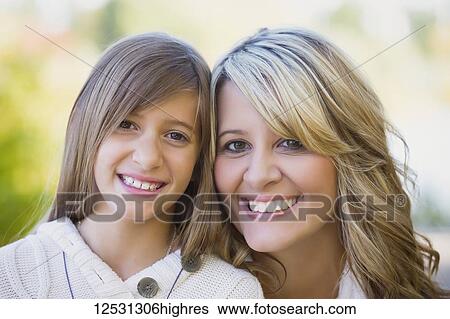Stock Photograph - Portrait of a mother and daughter in a park in autumn; Edmonton, Alberta, Canada. Fotosearch