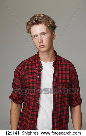 Portrait of a teenage boy wearing a red plaid shirt against a gray background View Large Photo Image Stock Photograph - Portrait of a teenage boy wearing a red plaid shirt against a gray background. Fotosearch