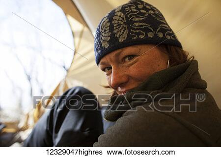 Portrait of a woman sitting in the tent; Alaska, United States of America View Large Photo Image Stock Photograph - Portrait of a woman sitting in the tent; Alaska, United States of America. Fotosearch