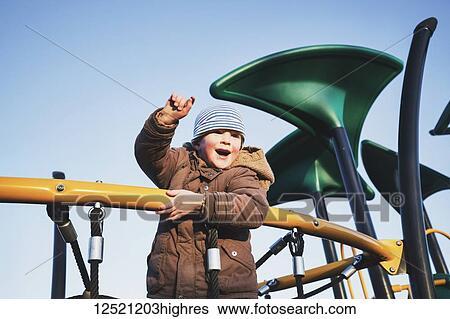 Portrait of a young boy playing on playground equipment; Langley, British Columbia, Canada View Large Photo Image Stock Photograph - Portrait of a young boy playing on playground equipment; Langley, British Columbia, Canada. Fotosearch