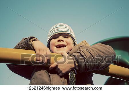 Portrait of a young boy playing on playground equipment; Langley, British Columbia, Canada View Large Photo Image Stock Photograph - Portrait of a young boy playing on playground equipment; Langley, British Columbia, Canada. Fotosearch