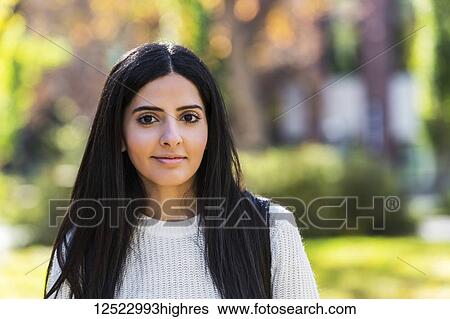 Stock Photograph - Portrait of a young female university student of Lebanese ethnicity on campus; Edmonton, Alberta, Canada. Fotosearch