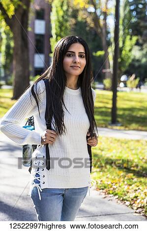 Stock Photograph - Portrait of a young female university student of Lebanese ethnicity on campus; Edmonton, Alberta, Canada. Fotosearch