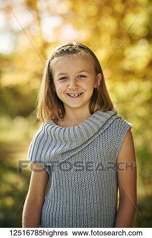 Portrait of a young girl with blond hair and braces, autumn coloured foliage in the background; Ontario, Canada View Large Photo Image Stock Photograph - Portrait of a young girl with blond hair and braces, autumn coloured foliage in the background; Ontario, Canada. Fotosearch