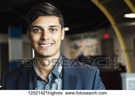 Portrait of a young millennial businessman in the workplace; Sherwood Park, Alberta, Canada View Large Photo Image Stock Photograph - Portrait of a young millennial businessman in the workplace; Sherwood Park, Alberta, Canada. Fotosearch