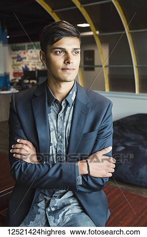 Portrait of a young millennial businessman in the workplace; Sherwood Park, Alberta, Canada View Large Photo Image Stock Photograph - Portrait of a young millennial businessman in the workplace; Sherwood Park, Alberta, Canada. Fotosearch