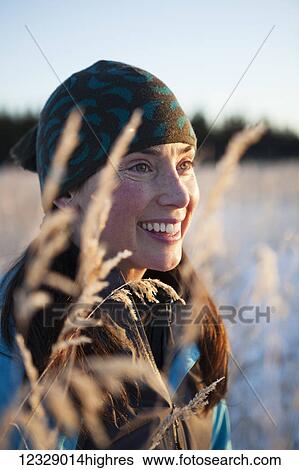 Portrait of a young woman wearing a knit hat and viewed through the tall grasses; Homer, Alaska, United States of America View Large Photo Image Stock Photograph - Portrait of a young woman wearing a knit hat and viewed through the tall grasses; Homer, Alaska, United States of America. Fotosearch