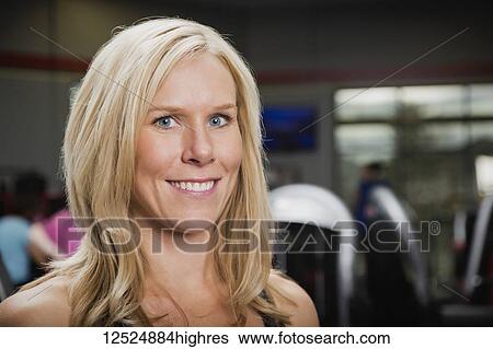 Portrait of an attractive middle-aged business woman who owns a fitness club and is a personal trainer; Spruce Grove, Alberta, Canada View Large Photo Image Stock Photograph - Portrait of an attractive middle-aged business woman who owns a fitness club and is a personal trainer; Spruce Grove, Alberta, Canada. Fotosearch
