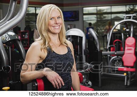 Stock Photograph - Portrait of an attractive middle-aged business woman who owns a fitness club and is a personal trainer; Spruce Grove, Alberta, Canada. Fotosearch