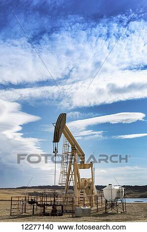 Pump jack with cloud bank and bue sky; Alberta, Canada View Large Photo Image Stock Image - Pump jack with cloud bank and bue sky; Alberta, Canada. Fotosearch