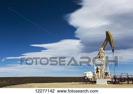 Pumpjack with dramatic cloud bank and blue sky; Alberta, Canada View Large Photo Image Stock Image - Pumpjack with dramatic cloud bank and blue sky; Alberta, Canada. Fotosearch