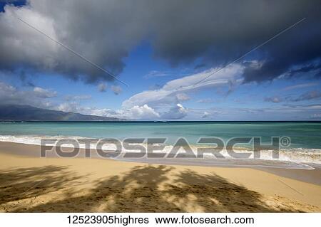 Stock Photograph - Rainbow over ocean and Baldwin Beach, on the North shore of Maui; Paia, Maui, Hawaii, United States of America. Fotosearch