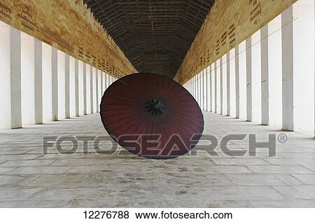 Red umbrella in a temple corridor; Bagan, Myanmar View Large Photo Image Stock Photo - Red umbrella in a temple corridor; Bagan, Myanmar. Fotosearch