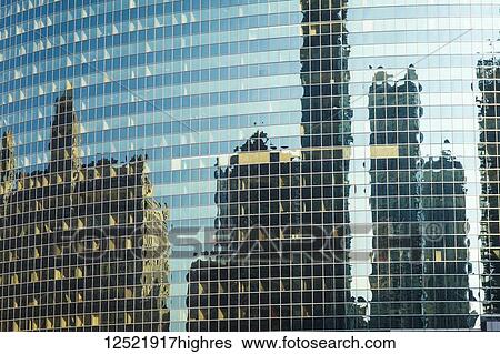 Stock Photograph - Reflection of skyscrapers in the glass facade of a building; Chicago, Illinois, United States of America. Fotosearch