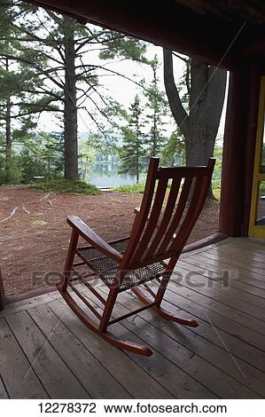 Rocking chair on the porch of a log cabin in the woods; Lac-des-Neiges, Quebec, Canada View Large Photo Image Stock Image - Rocking chair on the porch of a log cabin in the woods; Lac-des-Neiges, Quebec, Canada. Fotosearch
