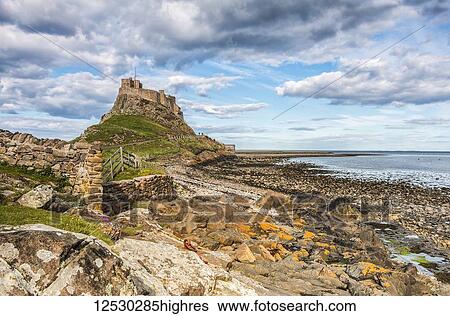 Rocky outcrop leading to Holy Island Castle on a beautiful spring day View Large Photo Image Stock Photograph - Rocky outcrop leading to Holy Island Castle on a beautiful spring day. Fotosearch