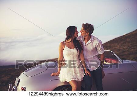 Romantic Young Attractive Couple Watching The Sunset With Classic Vintage Sports Car View Large Photo Image Stock Photograph - Romantic Young Attractive Couple Watching The Sunset With Classic Vintage Sports Car. Fotosearch