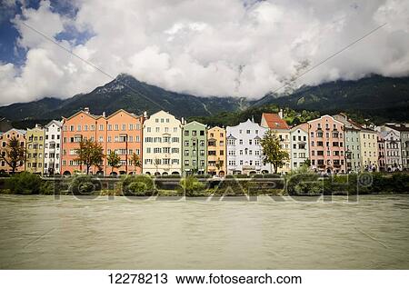Stock Image - Row of terraced houses nestled in the foothills of the mountains; Innsbruck, Austria. Fotosearch