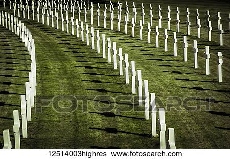 Stock Photograph - Rows of white crosses on grass, Cambridge American Cemetery and Memorial; Cambridge, Cambridgeshire, England. Fotosearch