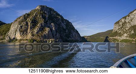 Rugged hills and cliffs along the water as viewed from a rowboat; Serbia View Large Photo Image Stock Photograph - Rugged hills and cliffs along the water as viewed from a rowboat; Serbia. Fotosearch
