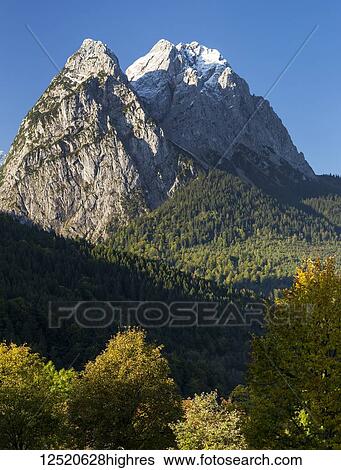 Rugged mountain peaks with blue sky; Grainau, Bavaria, Germany View Large Photo Image Stock Photograph - Rugged mountain peaks with blue sky; Grainau, Bavaria, Germany. Fotosearch