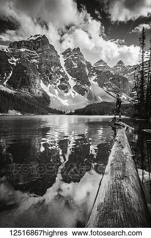 Stock Photograph - Rugged peaks of the Rocky Mountains reflected in a lake in Banff National Park; Alberta, Canada. Fotosearch