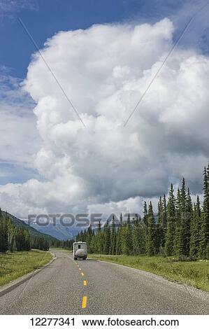 RV driving on the Alaska Highway with cumulonimbus clouds overhead, west of Fort Nelson, British Columbia, Canada, Summer View Large Photo Image Stock Image - RV driving on the Alaska Highway with cumulonimbus clouds overhead, west of Fort Nelson, British Columbia, Canada, Summer . Fotosearch